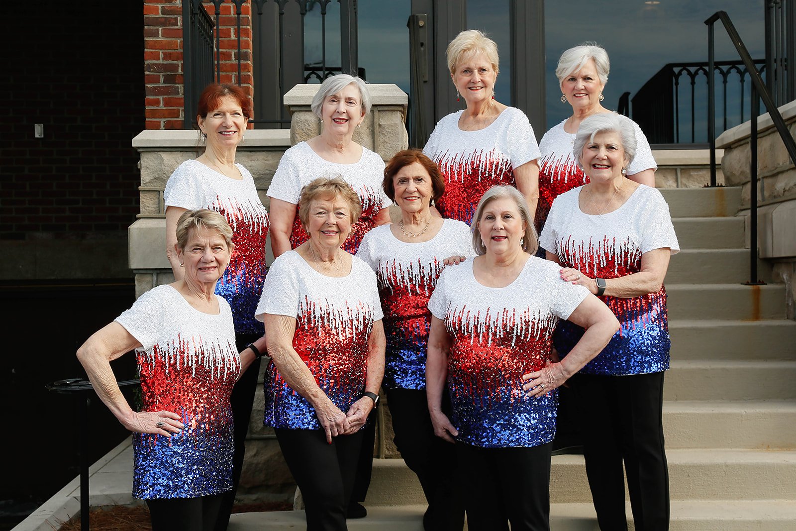 Sweet Harmony singers in patriotic outfits on outdoor steps